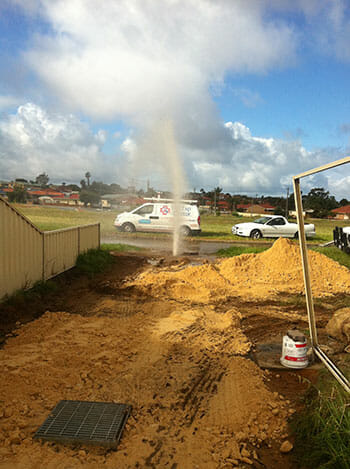 A burst pipe spraying water into the air