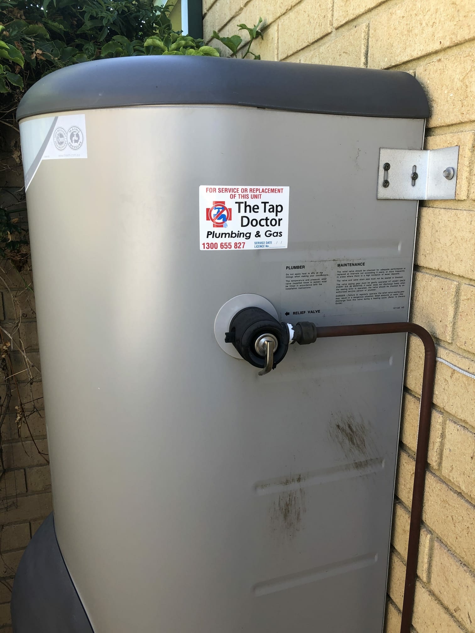 Hot water storage tank with a Tap Doctor service sticker